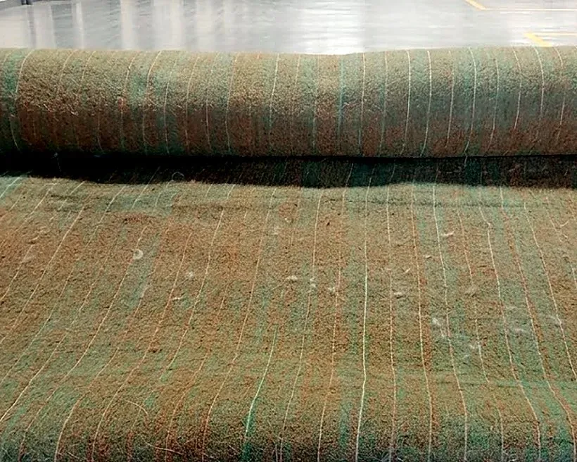 A roll of coir erosion control blanket unrolled on the floor