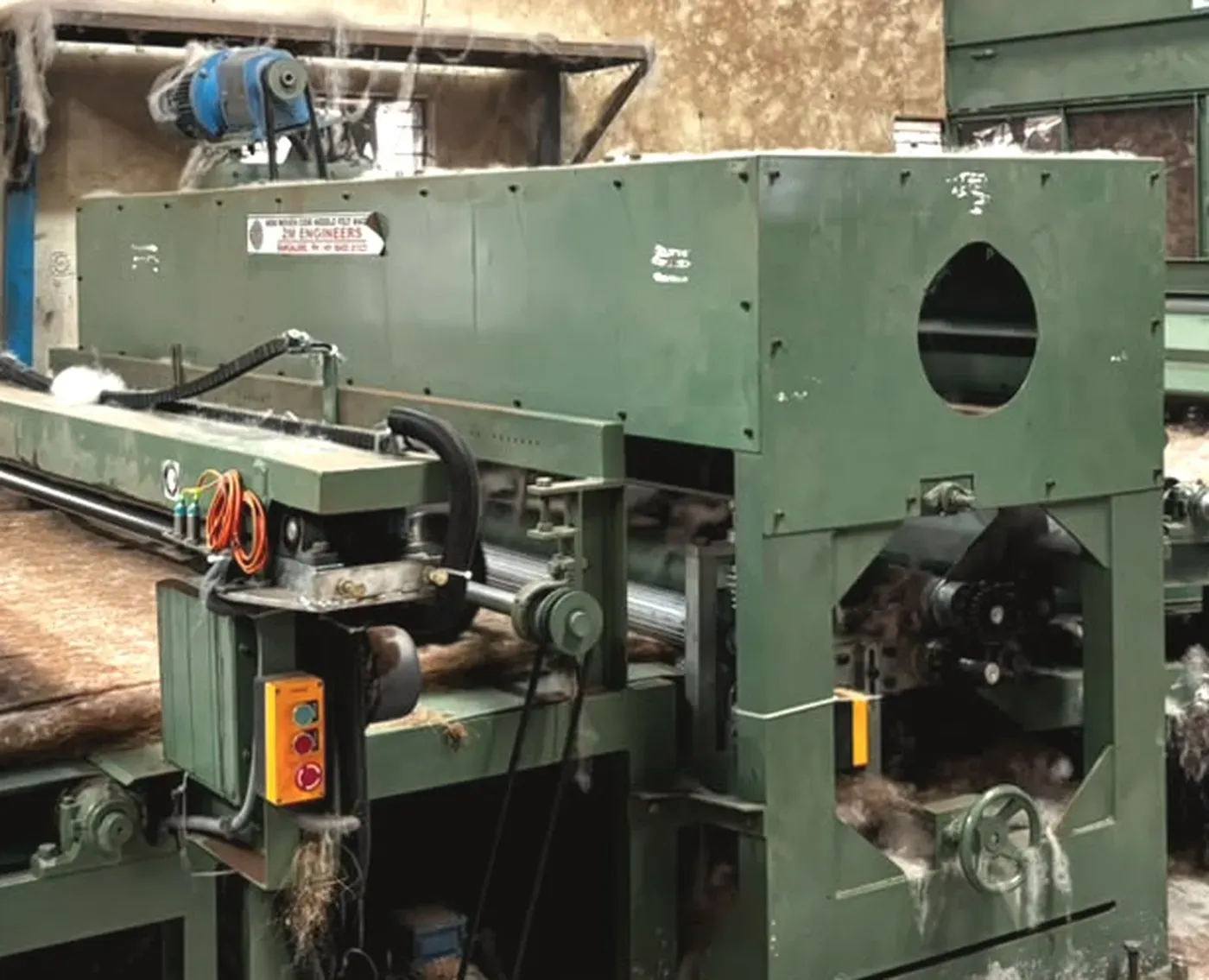 The needle loom and conveyor on 2M's own coir needle felt line at the Peenya works